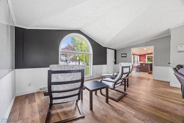 3022 Sandy Beach Rd, Hatton, ND 58240 - sitting room with vaulted ceiling, wood finished floors, a wainscoted wall, and ornamental molding