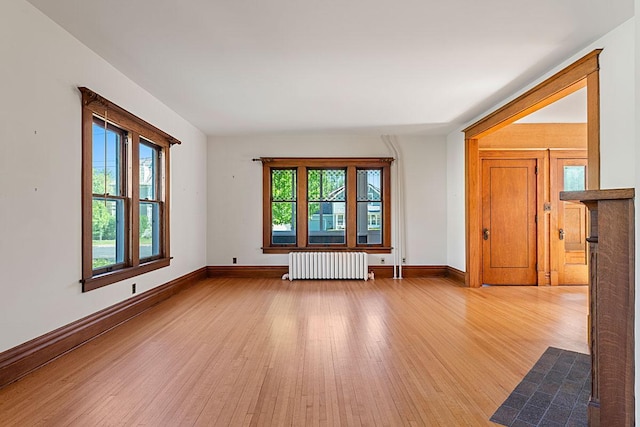 408 5th St E, Northfield, MN 55057 - unfurnished room with radiator, wood finished floors, and baseboards
