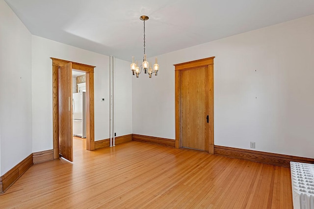 408 5th St E, Northfield, MN 55057 - empty room with light wood finished floors, baseboards, and a chandelier