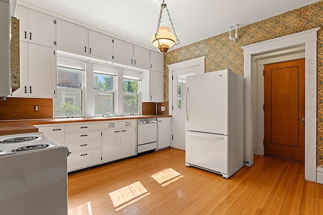 408 5th St E, Northfield, MN 55057 - kitchen with freestanding refrigerator, dishwasher, range with electric stovetop, wallpapered walls, and white cabinetry