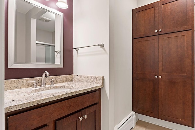 408 5th St E, Northfield, MN 55057 - full bathroom featuring a baseboard radiator, vanity, tile patterned flooring, and a closet