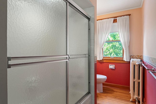 408 5th St E, Northfield, MN 55057 - bathroom with radiator, toilet, wood finished floors, and baseboards