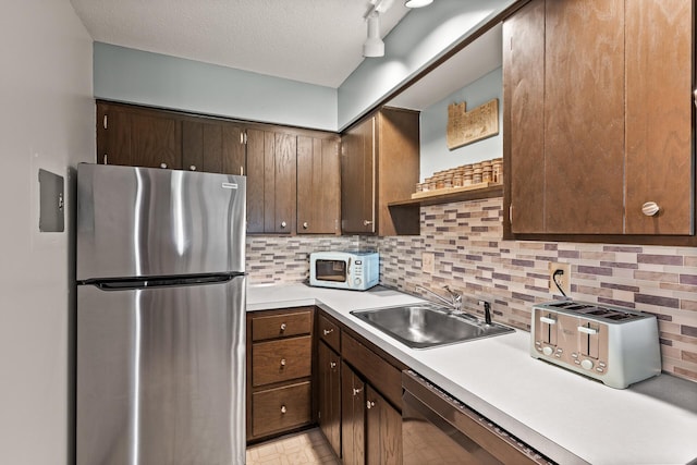 2200 Nevada Ave S Unit 320, Saint Louis Park, MN 55426 - kitchen with appliances with stainless steel finishes, open shelves, light countertops, tasteful backsplash, and a textured ceiling