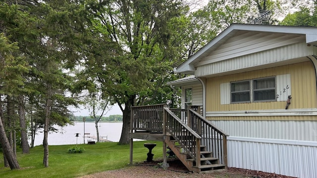 26302 Lakeview Dr, Comfort Twp, MN 55051 - view of side of property featuring a lawn, a water view, and stairs