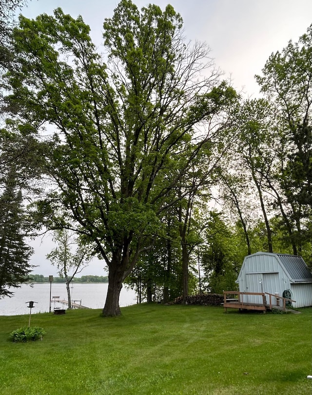 26302 Lakeview Dr, Comfort Twp, MN 55051 - view of green lawn featuring a water view and an outbuilding