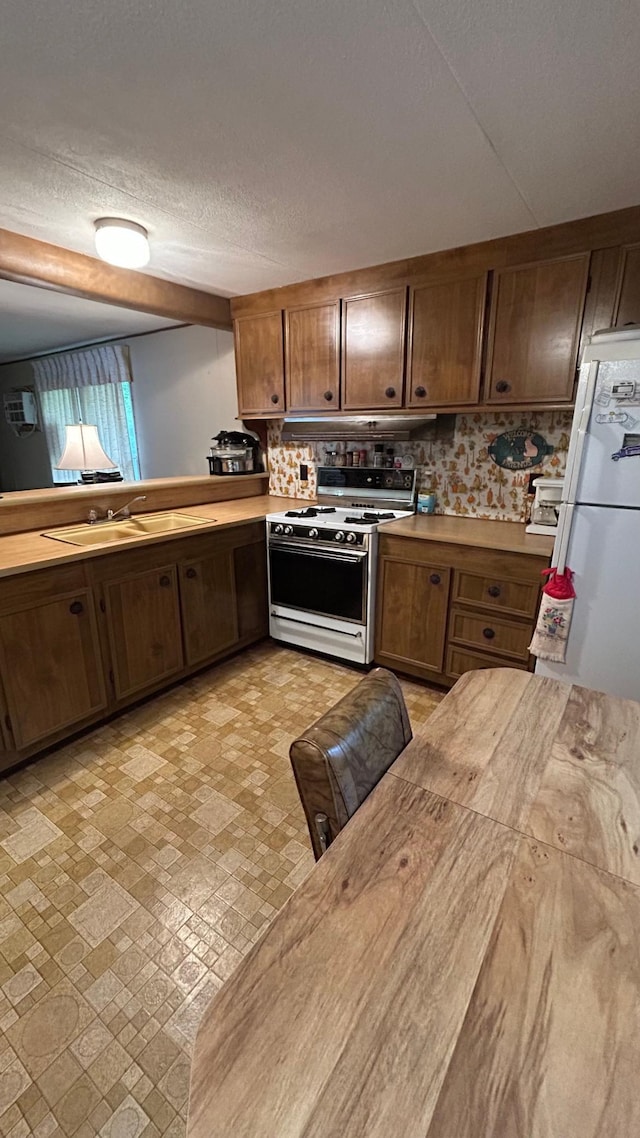 26302 Lakeview Dr, Comfort Twp, MN 55051 - kitchen featuring white appliances, a sink, light countertops, and a textured ceiling