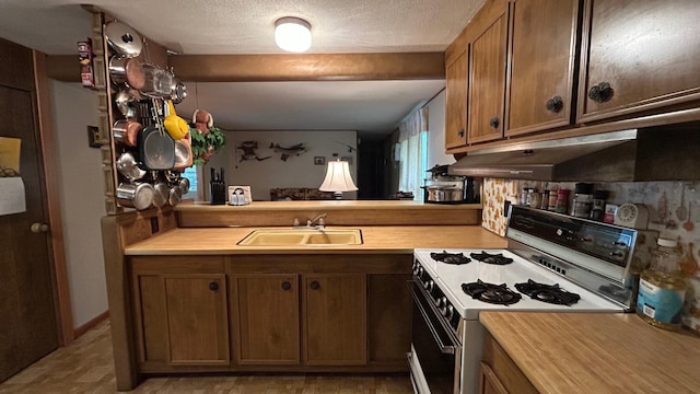 26302 Lakeview Dr, Comfort Twp, MN 55051 - kitchen featuring range with gas cooktop, a sink, light countertops, brown cabinets, and under cabinet range hood