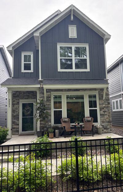 3081 Rum River Way, Anoka, MN 55303 - view of front of home with board and batten siding, covered porch, and stone siding