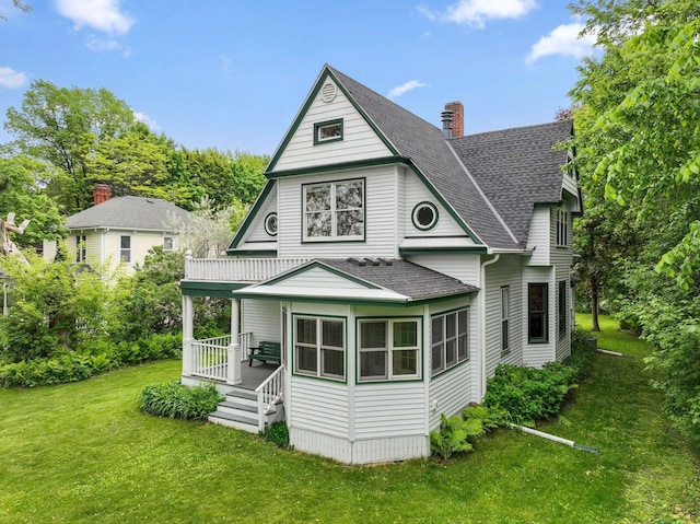 216 Summit Ave, Center City, MN 55012 - back of house with roof with shingles, a lawn, a chimney, and a porch