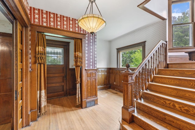 216 Summit Ave, Center City, MN 55012 - foyer entrance with wallpapered walls, a wainscoted wall, light wood-style floors, and stairway