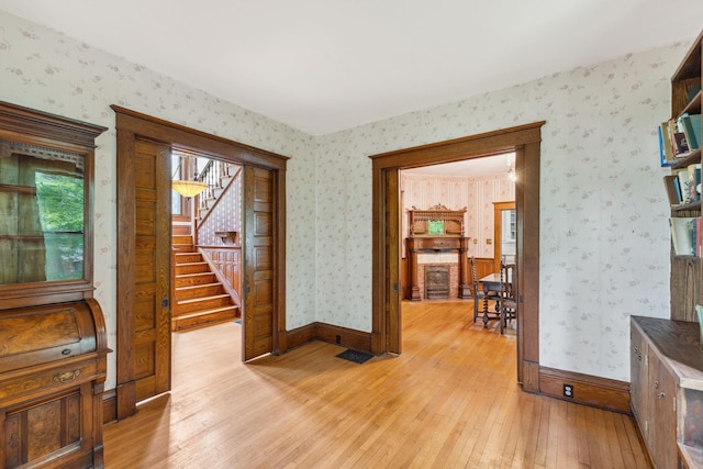 216 Summit Ave, Center City, MN 55012 - interior space featuring wallpapered walls, light wood-style flooring, stairway, and baseboards