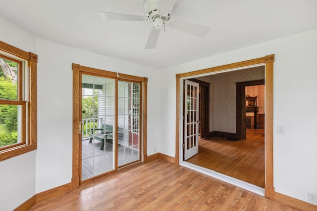 216 Summit Ave, Center City, MN 55012 - empty room featuring plenty of natural light, baseboards, light wood-style flooring, and a ceiling fan