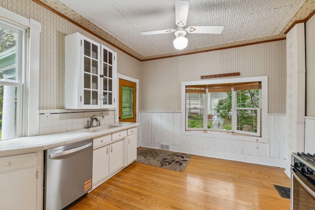 216 Summit Ave, Center City, MN 55012 - kitchen with appliances with stainless steel finishes, wallpapered walls, crown molding, light wood-style floors, and tile counters