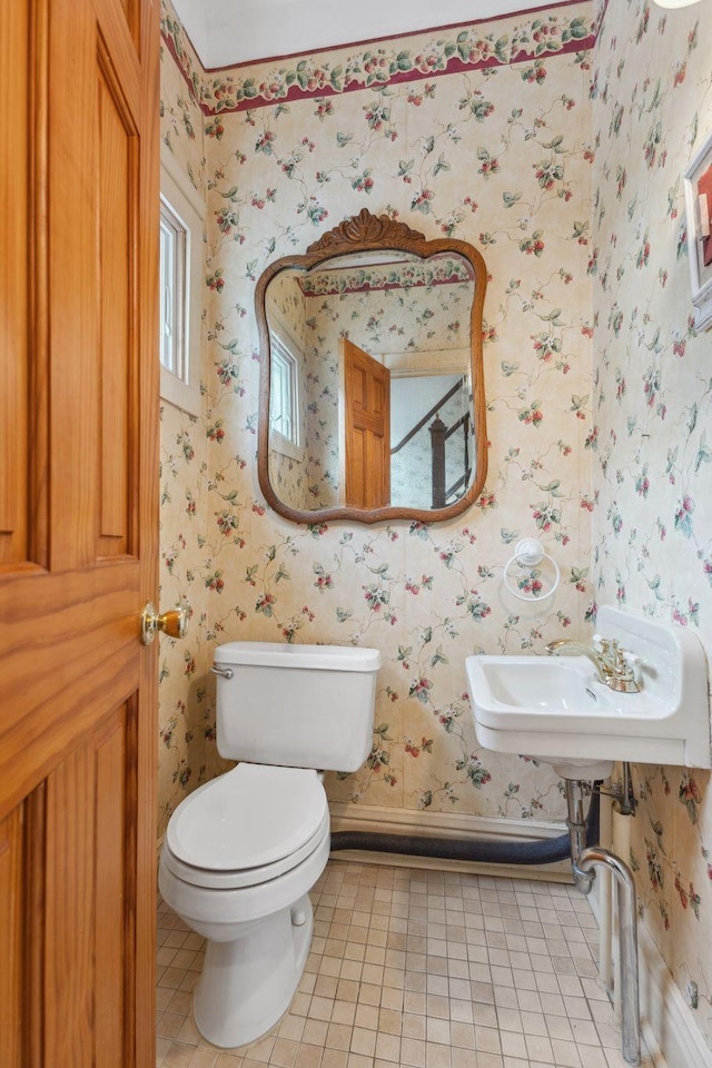 216 Summit Ave, Center City, MN 55012 - half bathroom featuring wallpapered walls, tile patterned flooring, toilet, and a sink