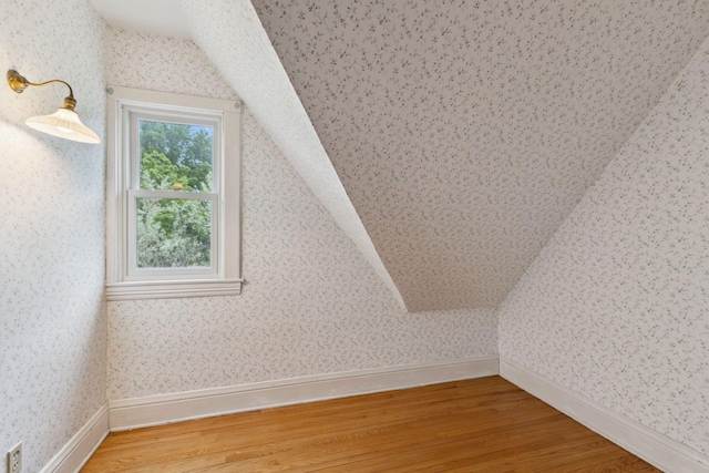216 Summit Ave, Center City, MN 55012 - bonus room featuring lofted ceiling, light wood finished floors, wallpapered walls, and baseboards
