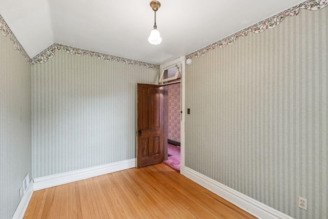 216 Summit Ave, Center City, MN 55012 - spare room with light wood-style floors, baseboards, wallpapered walls, and lofted ceiling