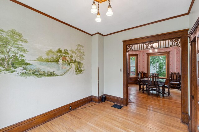 216 Summit Ave, Center City, MN 55012 - unfurnished room with light wood-type flooring, a chandelier, and ornamental molding