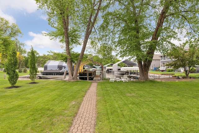 1709 Baywood Ln, Mound, MN 55364 - view of green lawn with boat lift and a boat dock