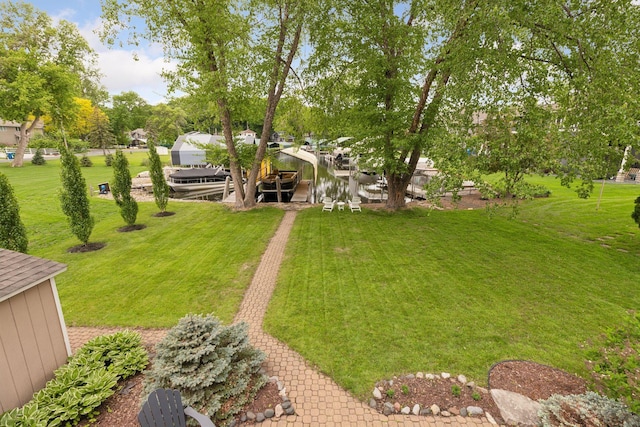 1709 Baywood Ln, Mound, MN 55364 - view of grassy yard featuring boat lift and a boat dock
