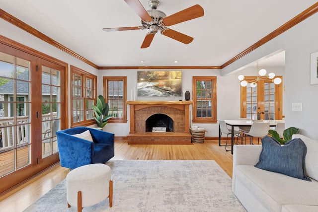 1709 Baywood Ln, Mound, MN 55364 - living room with plenty of natural light, wood finished floors, a fireplace with raised hearth, and ornamental molding