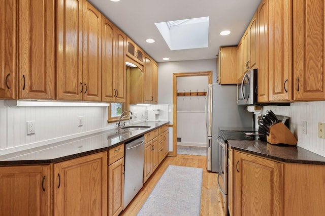 1709 Baywood Ln, Mound, MN 55364 - kitchen with stainless steel appliances, a sink, a skylight, light wood-type flooring, and recessed lighting