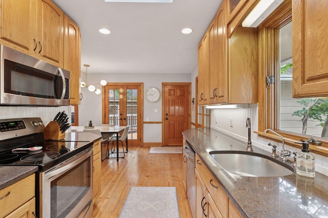 1709 Baywood Ln, Mound, MN 55364 - kitchen with stainless steel appliances, a sink, dark stone countertops, light wood-style flooring, and recessed lighting