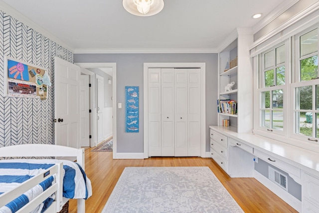 1709 Baywood Ln, Mound, MN 55364 - bedroom with light wood-style flooring, baseboards, crown molding, a closet, and an accent wall