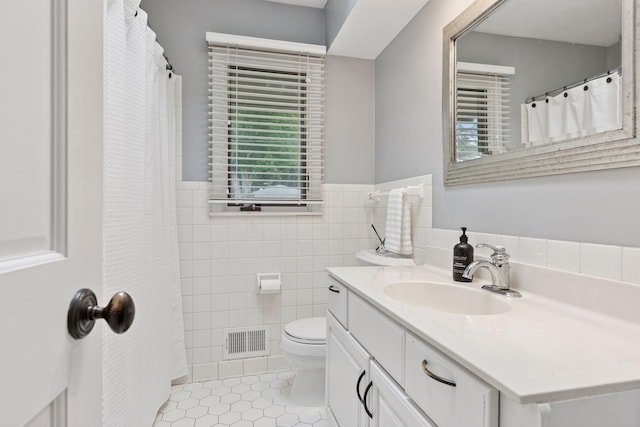 1709 Baywood Ln, Mound, MN 55364 - full bathroom with tile walls, tile patterned flooring, vanity, toilet, and wainscoting