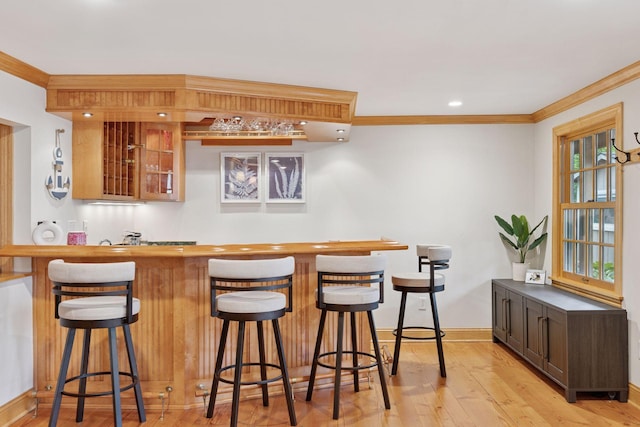 1709 Baywood Ln, Mound, MN 55364 - indoor wet bar featuring ornamental molding, baseboards, light wood-type flooring, and recessed lighting