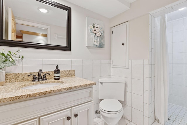 1709 Baywood Ln, Mound, MN 55364 - bathroom with tile walls, vanity, toilet, a tile shower, and a wainscoted wall