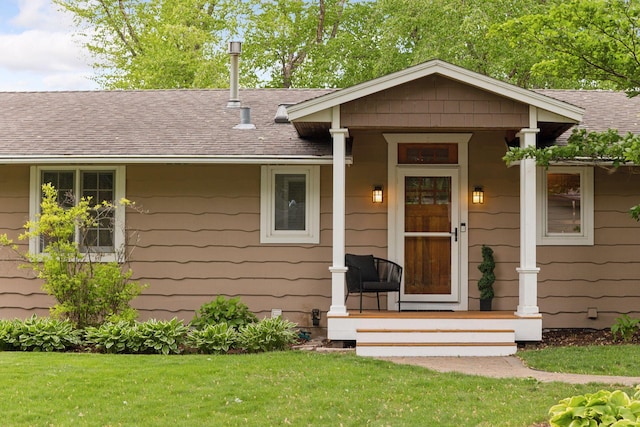 1709 Baywood Ln, Mound, MN 55364 - view of front facade featuring a shingled roof, covered porch, and a front lawn