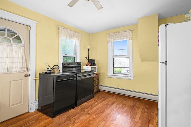 2718 3rd St, Duluth, MN 55806 - kitchen with black appliances, baseboard heating, plenty of natural light, and a ceiling fan