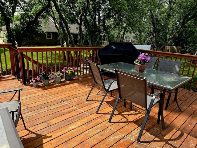 1612 17th St SW, Austin, MN 55912 - wooden deck featuring outdoor dining space and a grill