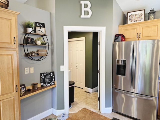 1612 17th St SW, Austin, MN 55912 - kitchen featuring stainless steel fridge with ice dispenser, light brown cabinetry, baseboards, and light tile patterned flooring