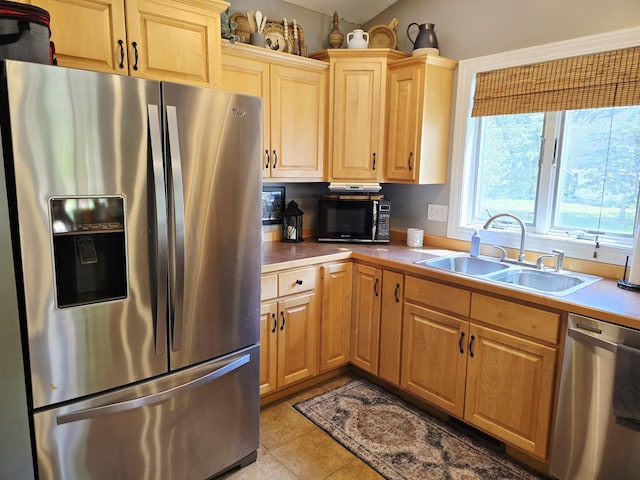 1612 17th St SW, Austin, MN 55912 - kitchen with appliances with stainless steel finishes, a sink, light tile patterned flooring, light countertops, and light brown cabinetry