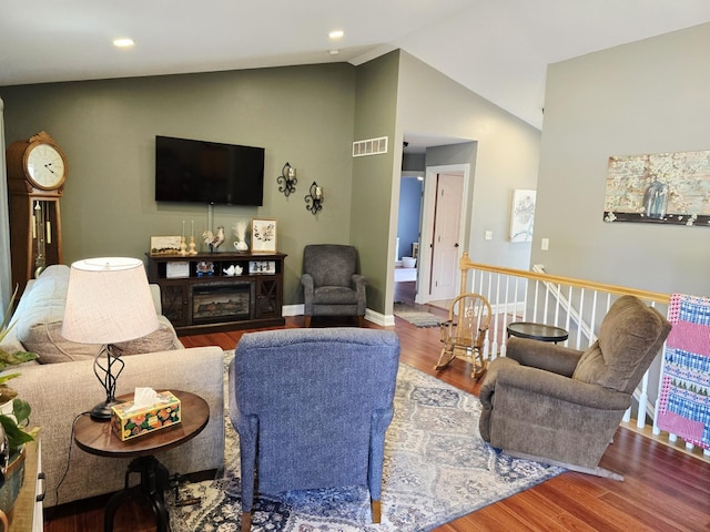1612 17th St SW, Austin, MN 55912 - living area with vaulted ceiling, wood finished floors, baseboards, and recessed lighting