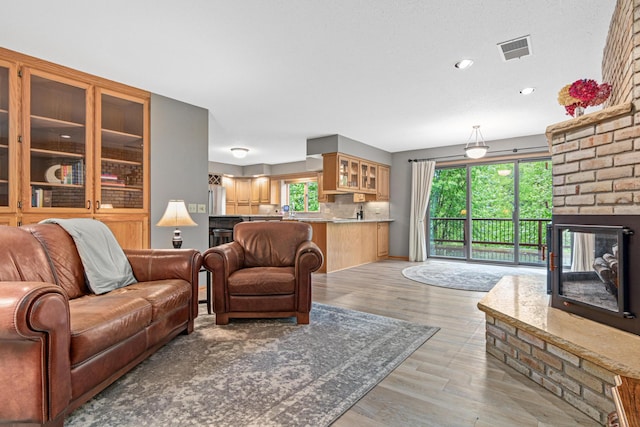 1515 18th Ave, Pleasant Valley Twp, WI 54022 - living area featuring light wood finished floors, a fireplace, and recessed lighting