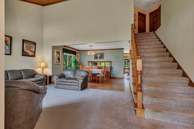 2904 Park Dr, Saint Cloud, MN 56303 - carpeted living room with a chandelier, a towering ceiling, ornamental molding, and stairs
