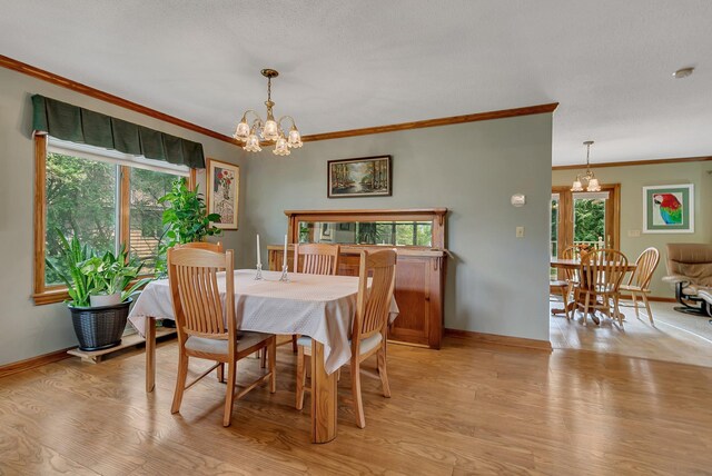 2904 Park Dr, Saint Cloud, MN 56303 - dining space with a chandelier, crown molding, and light wood-style flooring