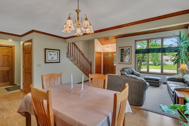2904 Park Dr, Saint Cloud, MN 56303 - dining room with stairs, a chandelier, light wood-type flooring, and ornamental molding