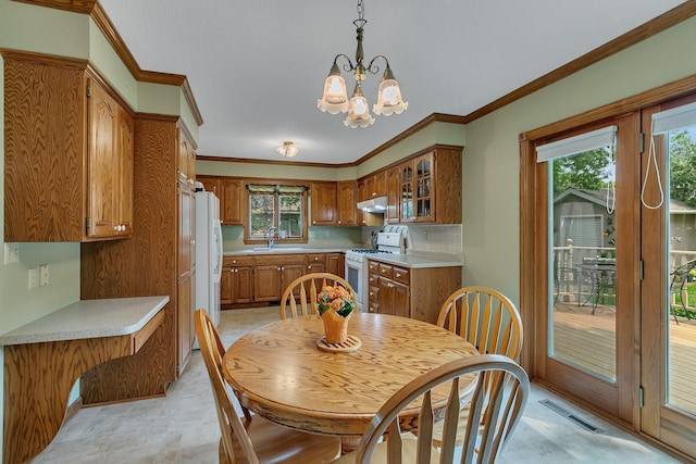 2904 Park Dr, Saint Cloud, MN 56303 - dining area featuring plenty of natural light, a chandelier, and crown molding