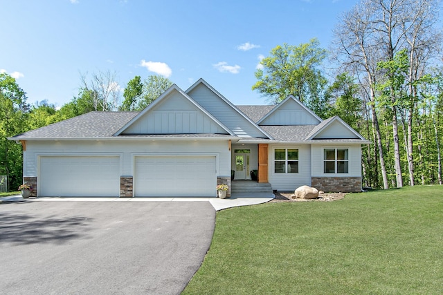 31709 Green Scene Dr, Breezy Point, MN 56472 - view of front of house with asphalt driveway, board and batten siding, stone siding, a garage, and a front yard