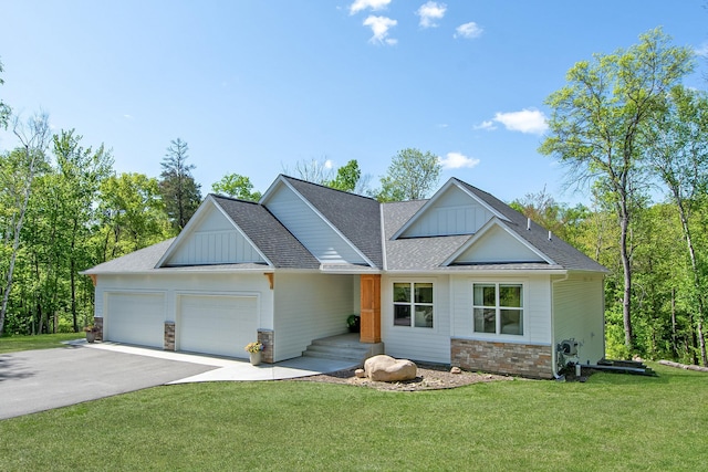31709 Green Scene Dr, Breezy Point, MN 56472 - view of front facade featuring an attached garage, driveway, board and batten siding, a front lawn, and roof with shingles