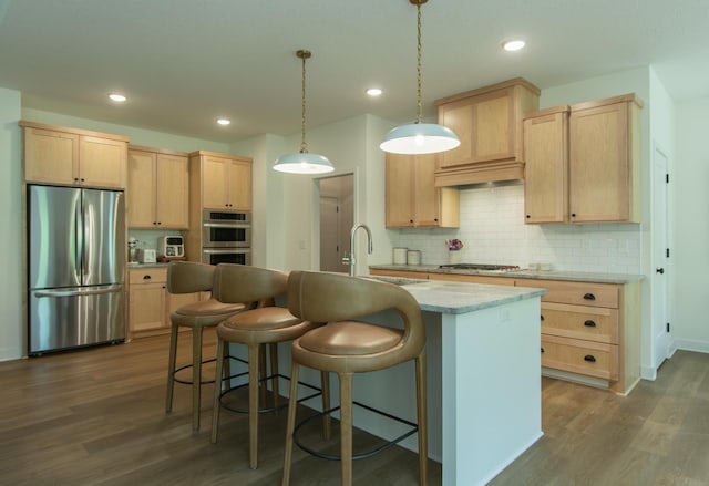 31709 Green Scene Dr, Breezy Point, MN 56472 - kitchen with stainless steel appliances, light brown cabinetry, dark wood-style flooring, an island with sink, and decorative backsplash