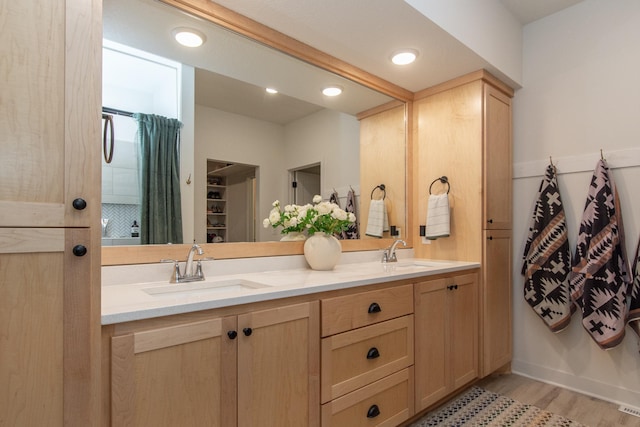 31709 Green Scene Dr, Breezy Point, MN 56472 - full bathroom featuring double vanity, wood finished floors, curtained shower, and a closet
