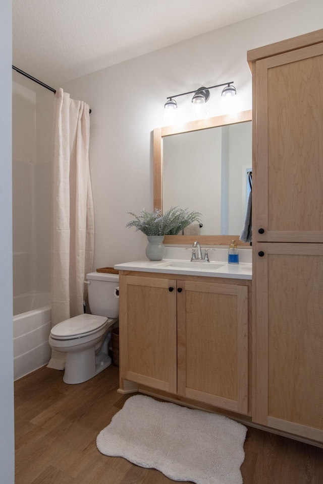 31709 Green Scene Dr, Breezy Point, MN 56472 - bathroom featuring toilet, wood finished floors, vanity, and shower / bath combo with shower curtain