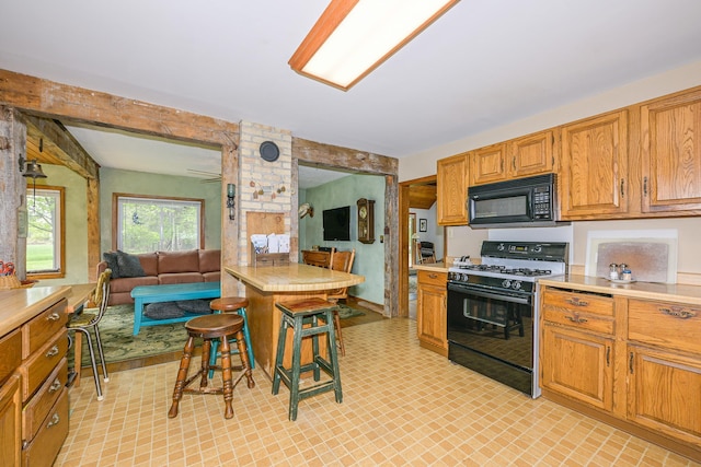 2444 County Rd 1, Wrenshall, MN 55797 - kitchen featuring black appliances, light countertops, open floor plan, and brown cabinets