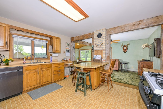 2444 County Rd 1, Wrenshall, MN 55797 - kitchen with dishwasher, a sink, range with gas cooktop, light countertops, and a kitchen breakfast bar