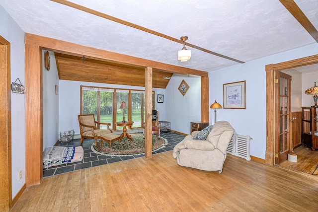2444 County Rd 1, Wrenshall, MN 55797 - living room with wood finished floors, beamed ceiling, baseboards, and a textured ceiling