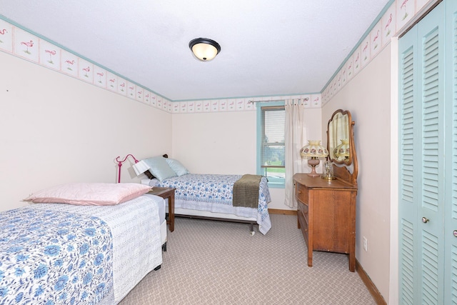 2444 County Rd 1, Wrenshall, MN 55797 - bedroom featuring light carpet, a closet, and baseboards
